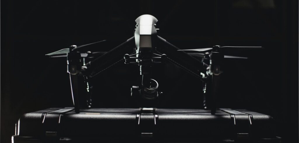 Close-up of a professional drone and its storage case, showcasing sleek design.